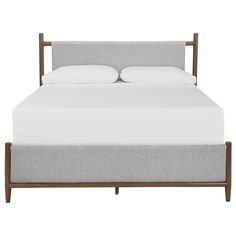 a bed with white sheets and pillows on top of it, in front of a white background