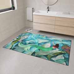 a bathroom with a rug on the floor that has an image of mermaids swimming in water