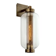 an old fashioned wall light with a glass shade