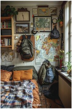 a bedroom with a map on the wall and backpacks hanging up against the wall