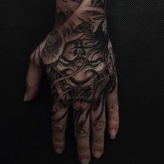 a man's hand with a tattoo on it