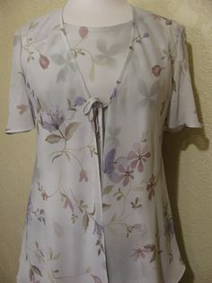 This is a very pretty 2 piece sleeveless long layered dress with matching long sheer chiffon jacket by r&m richards. still in brand new condition. it is a size 8. please go by the measurements below for proper fit. very elegant pretty women look. perfect for a garden party or summer wedding. the dress has a modest scoop neckline with a small keyhole button back. the dress is made of a pastel light sage green floral print crepe chiffon. the flowers are very light pastels of pinks and periwink Spring Formal Dress With Overlay, Spring Formal Dress With Open Front, Spring Formal Open Front Dresses, Spring Open Front Flowy Dresses, Flowy Open Front Spring Dress, Flowy Open Front Dress For Spring, Fitted Open Front Dress For Spring, Long Layered Dress, Sage Green Floral Dress