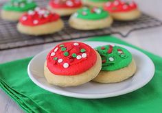 cookies decorated with green and red frosting on a plate