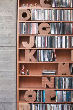 a bookshelf filled with lots of different types of cds