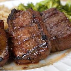 some meat and broccoli on a white plate