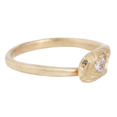 a gold ring with two diamonds on it