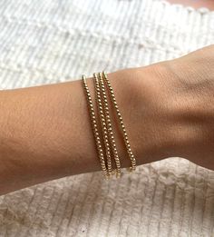 The Mini Bead Bracelet has 14K Gold Filled 2mm beads. This beautiful bracelet is beautiful for that minimalist look but also the perfect bracelet to add to your growing stack.  This bracelet has a little bit of stretch.  Please make sure to measure your wrist at the widest part so you know your size. Dainty Hypoallergenic Stretch Bracelet For Everyday, Minimalist Stretch Bracelet With Round Beads For Everyday, Minimalist Stretch Bracelet With Round Beads, Minimalist Stackable Stretch Bracelet For Everyday, Minimalist Everyday Stretch Bracelet With Round Beads, Dainty Stackable Round Bead Bracelets, Minimalist Hand-strung Stretch Bracelet For Everyday, Dainty Stackable Bracelets With Round Beads, Minimalist Yellow Gold Stretch Bracelet For Everyday