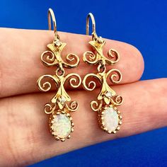 * Art Deco Art Nouveau 14K Yellow Gold Opal Diamond Scroll Drop Dangle Earrings * Length: 1-1/4" * Width: 1/4" to 1/2" * Opals measure: approximately 7.0 mm x 5.0 mm each * Diamonds measure: approximately 1.5 mm each * Weight: 5.1 tgw * Marked: 14K*Makers Marks * Condition: Great * G1187    Exported By ExportYourStore :) Art Deco Art, Deco Art, Drop Dangle Earrings, Etsy Earrings Dangle, Vintage Watches, Antique Jewelry, Vintage Antiques, Jewelry Earrings Dangle, Art Nouveau