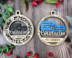 two medals are sitting on a table next to some red flowers and green leaves,