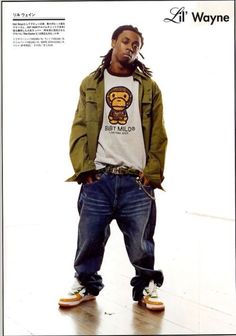 a man standing on top of a wooden floor wearing jeans and a t - shirt