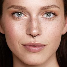 a woman with freckles on her face and nose