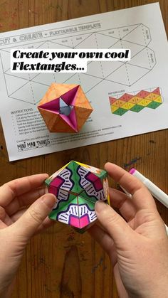 someone is making an origami cube out of paper