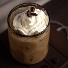 there is a drink with whipped cream and nuts on top