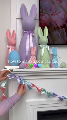 someone is decorating some bunny statues on the mantle in their living room with ribbons