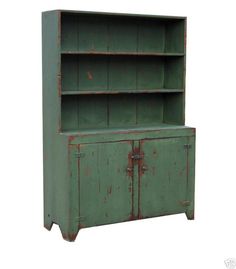 an old green metal cabinet with two doors