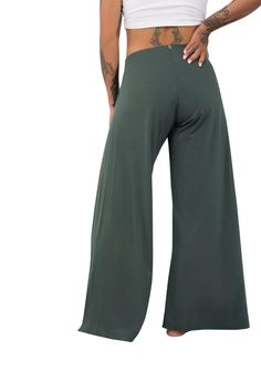 Our wide leg olive green pants by Ekoluxe. A perfect summer style, work from home outfit, beach date outfit or best everyday fashion ideas. Flowy pants with breezy side slits, drawstring wrap & tie style, accented with gold branded charms. Create a boho look, cozy clothes aesthetic or baggy pants outfit style with our wide leg trousers. We focus on ethical chic lounge wear for women using sustainable materials, handcrafted with purpose & versatility. Learn more at Ekoluxe.co #alwaysdoboth Cozy Clothes Aesthetic, Green Flowy Pants, Beach Date Outfit, Split Leg Pants, Baggy Pants Outfit, Cozy Clothes, Flowy Wide Leg Pants, Work From Home Outfit, Chic Lounge