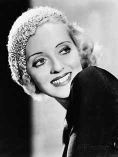 an old black and white photo of a woman with blonde hair wearing a headband