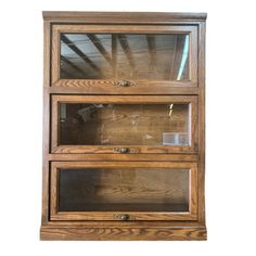 a wooden display case with glass doors on the front and bottom shelves, against a white background