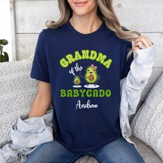 With love we made this CUSTOMIZABLE GRANDMA SHIRT of a baby boy or baby girl featuring cute Nanacado and Babycado in cartoon style. All embellished with the name of Grandchild and the text GRANDMA OF BABYCADO plus kid name. This FUNNY AVOCADO GRAMMY tee is the PERFECT PROPOSAL FOR NEW GRANDMOM from Children on the occasion of the first grandchildbirth, her first birthday as GIGI or her 1st Mother's Day as MIMI Valentine's day, Anniversary, first Christmas as GRAMMIE. This CUTE PERSONALIZED AVOCA Family Matching Custom Name T-shirt As A Gift, Family Matching T-shirt With Custom Name As Gift, Custom Name Family Matching T-shirt, Custom Name T-shirt For Family Matching Gift, Cute T-shirt With Name Print For Gift, Custom Name Cotton T-shirt As Gift, Cute Name Print T-shirt For Gift, Cute T-shirt With Name Print As Gift, Playful Personalized T-shirt For Gift