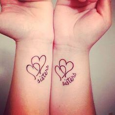 two wrist tattoos with hearts on them and the words sister and sister written in cursive