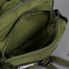 the inside of a green backpack with zippers