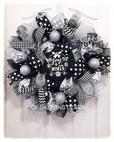 a black and white wreath with polka dots, bows and snowflakes on it