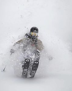 a man riding skis down a snow covered slope