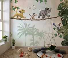 a child's room decorated with jungle animals and palm trees, including lions on a tree branch