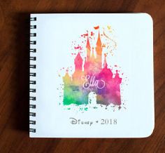 a notebook with the disney castle logo on it