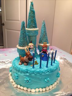 a frozen princess birthday cake with blue frosting