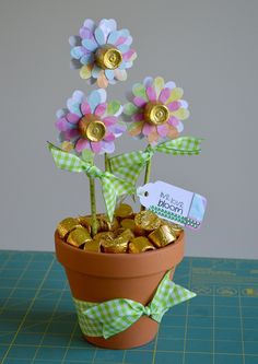 a flower pot filled with candy and gold coins