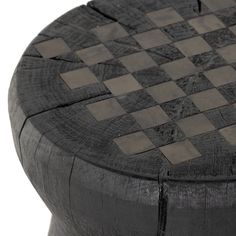 a black and white checkerboard stool with wood grained finish on the top