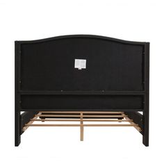 a black bed frame with wooden slats