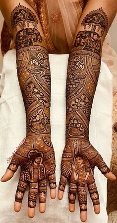 two hands with henna tattoos on them