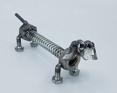 a small metal dog made to look like it is holding a screw in its mouth