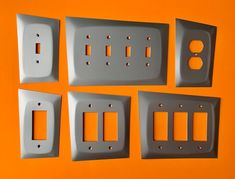 four switchplates are shown on an orange background