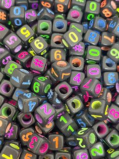 many different colored letters and numbers are arranged in the shape of cubes on top of each other