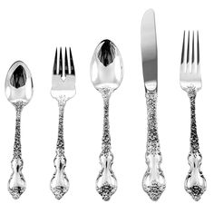 an assortment of silverware including forks, knives and spoons on a white background