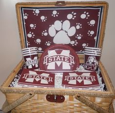 a picnic basket with state flags and plates in it