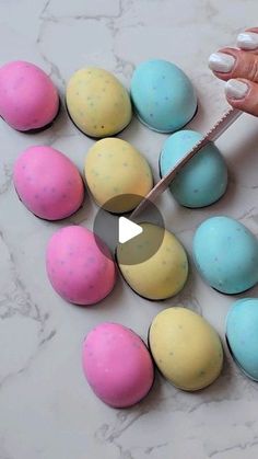 someone is cutting out colored eggs with a knife