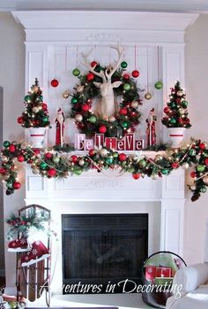 christmas decorations are displayed in front of a fireplace