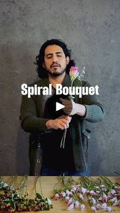 a man standing in front of a table with flowers on it and the words spiral bouquet