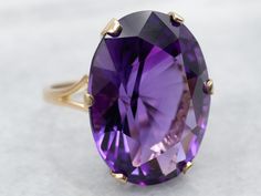 This is a beautiful piece! The ring itself is yellow gold with a simple, minimalist flair. We've set the center with a richly colored, perfectly cut amethyst of the highest quality. This combination of colors and light is outstanding on the hand, and absolutely unique in structure. Metal: 14K Yellow GoldGem: Amethyst 28.20 CaratsGem Measurements: 17.7 x 24.2 mm, OvalRing Size: 7.50Marks: "14K *" Stamped on the inside band The Hand, The Ring, Amethyst Ring, Cocktail Ring, Cocktail Rings, Amethyst, Yellow Gold, Size 7, Band