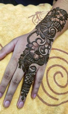 a person's hand with henna tattoos on it