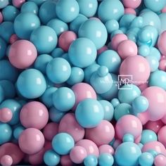 blue and pink balloons are in a bowl