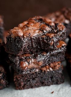 chocolate brownies stacked on top of each other with one bite taken out of it