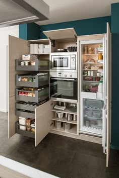 an open refrigerator freezer sitting inside of a kitchen