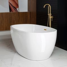 a large white bath tub sitting on top of a bathroom floor next to a sink