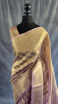 Our exquisite Tissue Saree, a masterpiece of elegance and tradition. Crafted with meticulous care, this saree features intricate Banarasi gold zari weaving adorning the border and pallu, adding a touch of regal allure to every drape. The luxurious fabric of tissue creates a subtle shimmer, enhancing the overall allure of the ensemble. Delicately finished with tassels on the pallu, this saree embodies timeless beauty and grace, perfect for any special occasion.  The saree is finished using 3D dyi Luxury Pre-draped Saree With Zari Weaving For Puja, Luxury Gold Pre-draped Saree With Zari Weaving, Luxury Lace Saree With Pallu, Luxury Gold Pre-draped Saree For Puja, Luxury Gold Pre-draped Saree With Border, Luxury Elegant Pre-draped Saree With Zari Weaving, Luxury Semi-stitched Dupatta With Zari Weaving, Luxury Art Silk Dress With Zari Weaving, Luxury Gold Saree With Intricate Embroidery