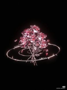 a bunch of pink flowers sitting on top of a metal stand in the middle of a dark room